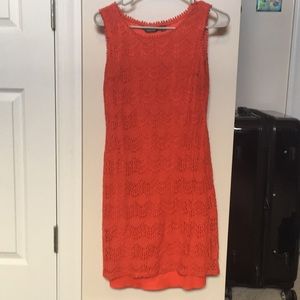 Orange/red sleeveless dress with lace-like fabric.